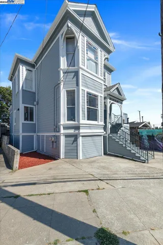 a view of a house with a door and wooden fence