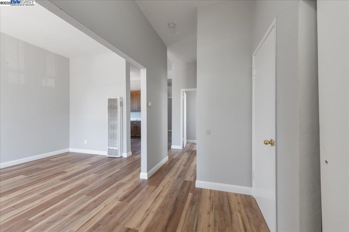 3214 13th Avenue Oakland, CA 94610 - Photo 6 of 51 a view of a hallway with wooden floor