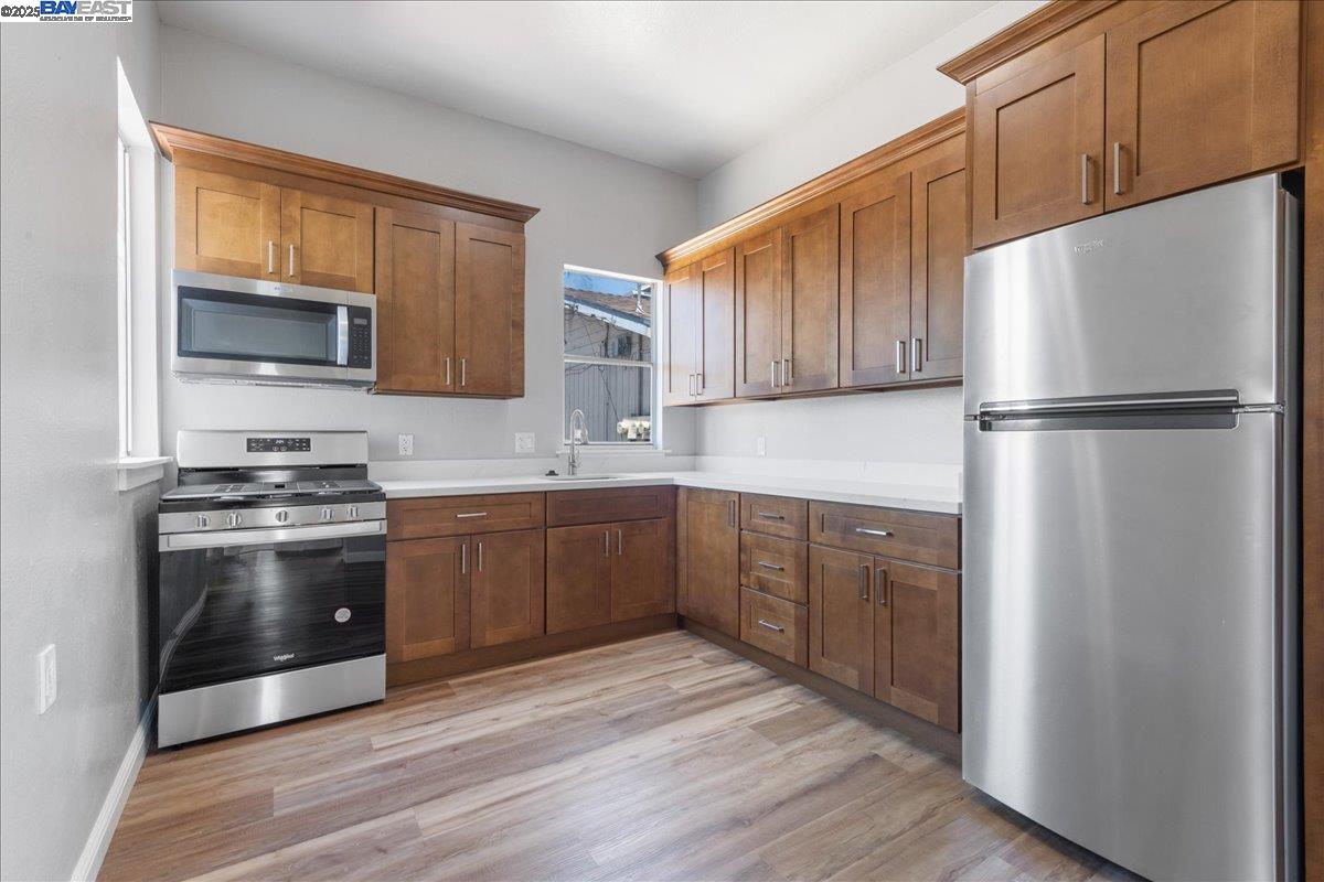 3214 13th Avenue Oakland, CA 94610 - Photo 7 of 51 a kitchen with a refrigerator sink and microwave
