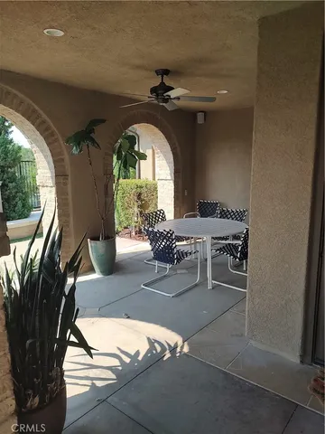 a view of a swimming pool with lawn chairs under an umbrella