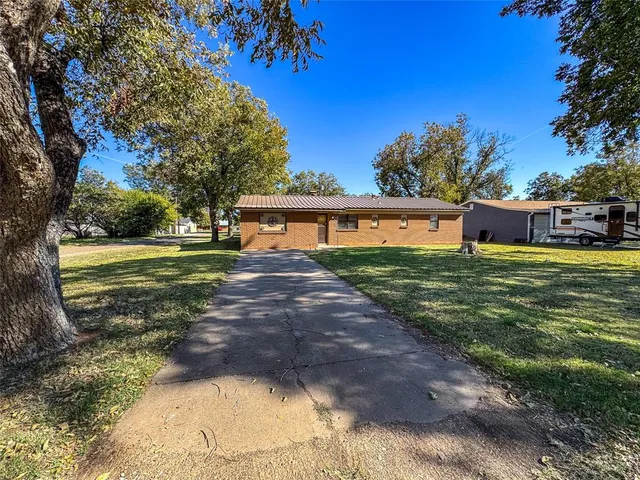 a view of a house with yard and sitting area