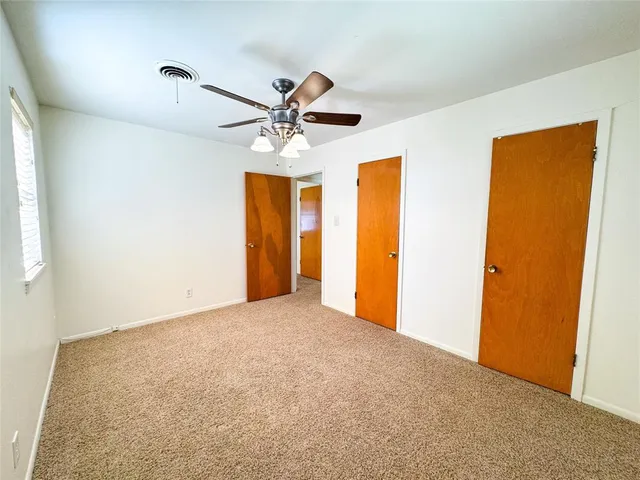 a view of house with backyard and a tree