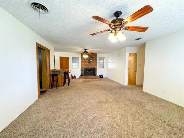 a view of a livingroom with a ceiling fan and window