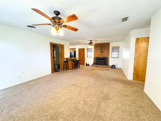 a view of a livingroom with a ceiling fan and window