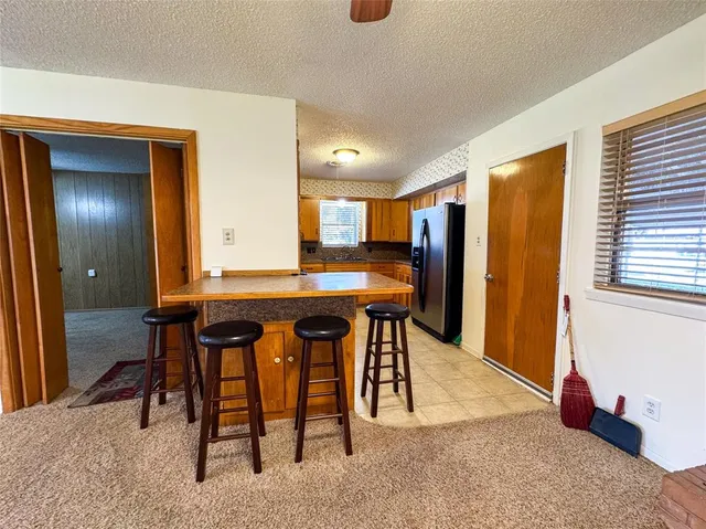 a view of a dining room with furniture and a window