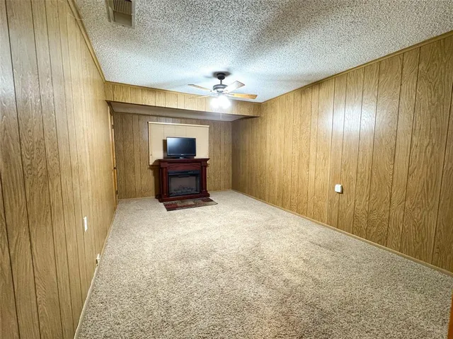 a furnished livingroom with a chandelier fan and wooden floor