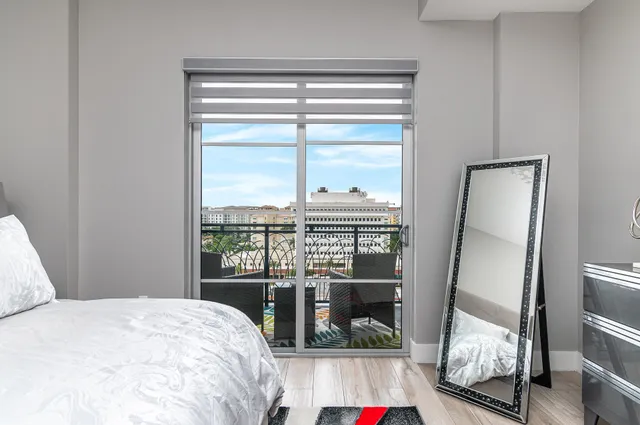 a bedroom with a bed and glass door