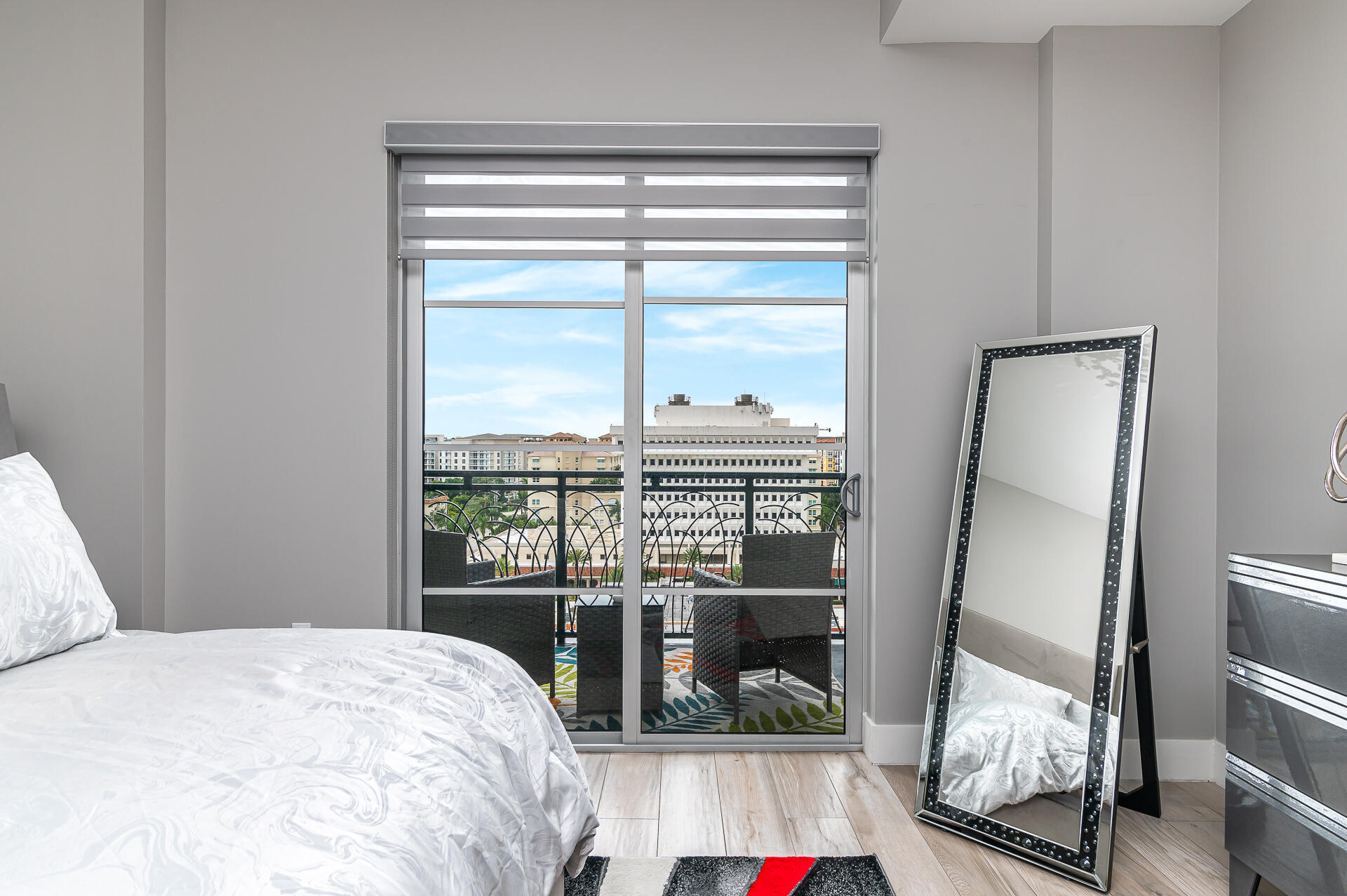 155 East Boca Raton Road, Unit 1012 Boca Raton, FL 33432 - Photo 10 of 41 a bedroom with a bed and glass door