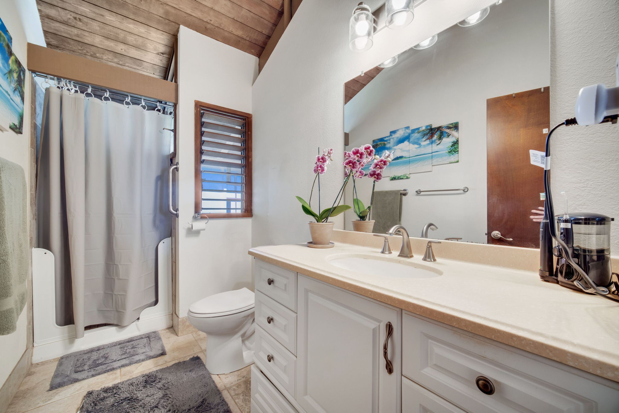 4701 Kawaihau Road, Unit F201 Kapaa, HI 96746 - Photo 15 of 24 a bathroom with a sink a toilet and shower curtain
