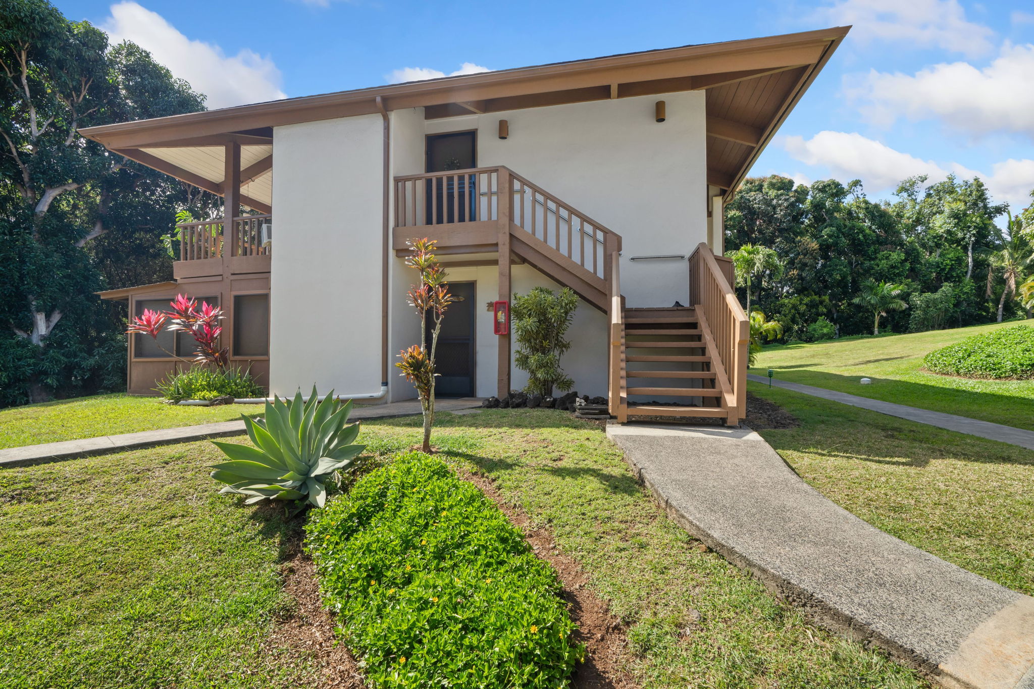4701 Kawaihau Road, Unit F201 Kapaa, HI 96746 - Photo 19 of 24 a front view of a house with garden