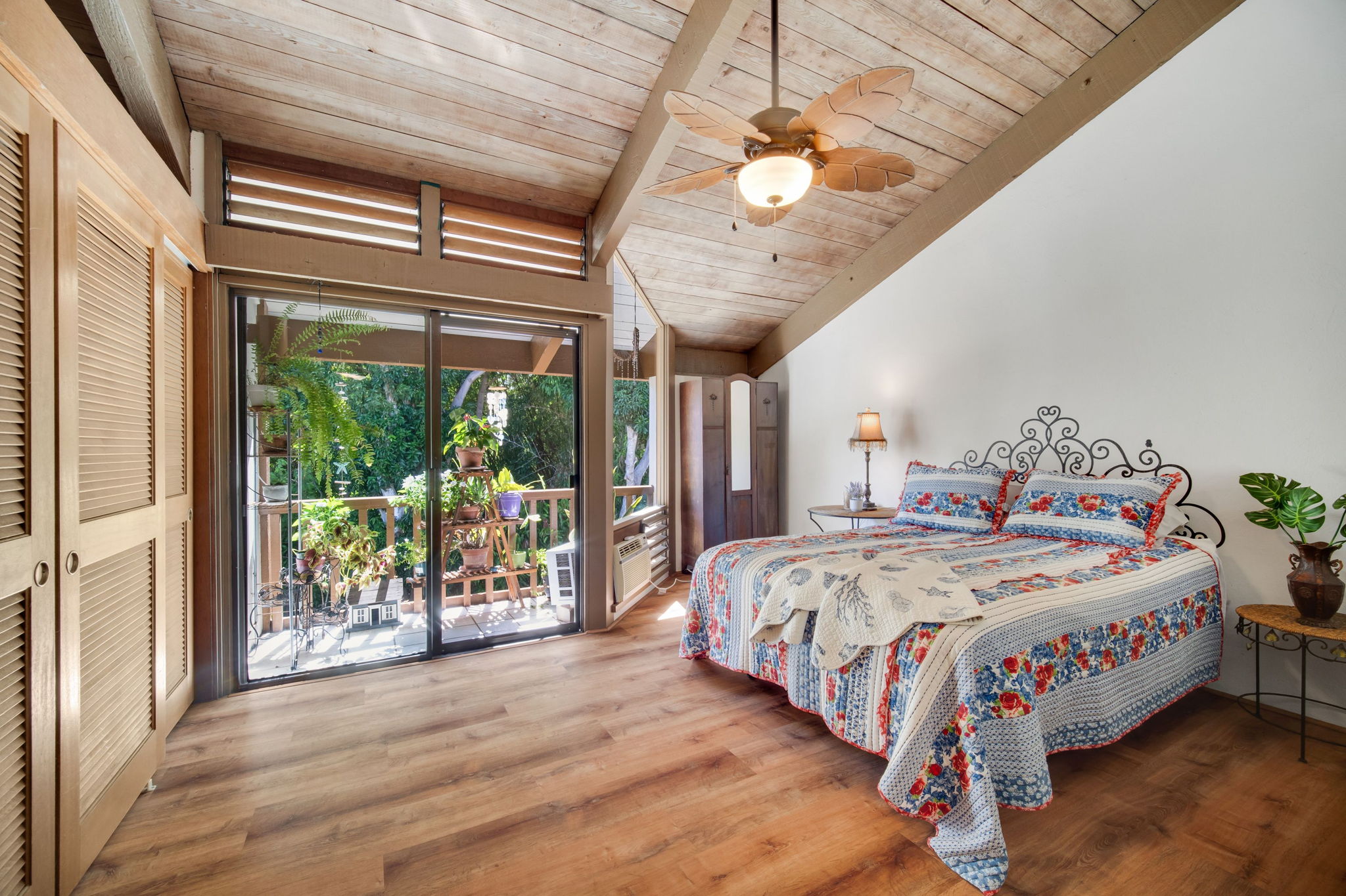 4701 Kawaihau Road, Unit F201 Kapaa, HI 96746 - Photo 9 of 24 a bedroom with a bed and a large window with garden view