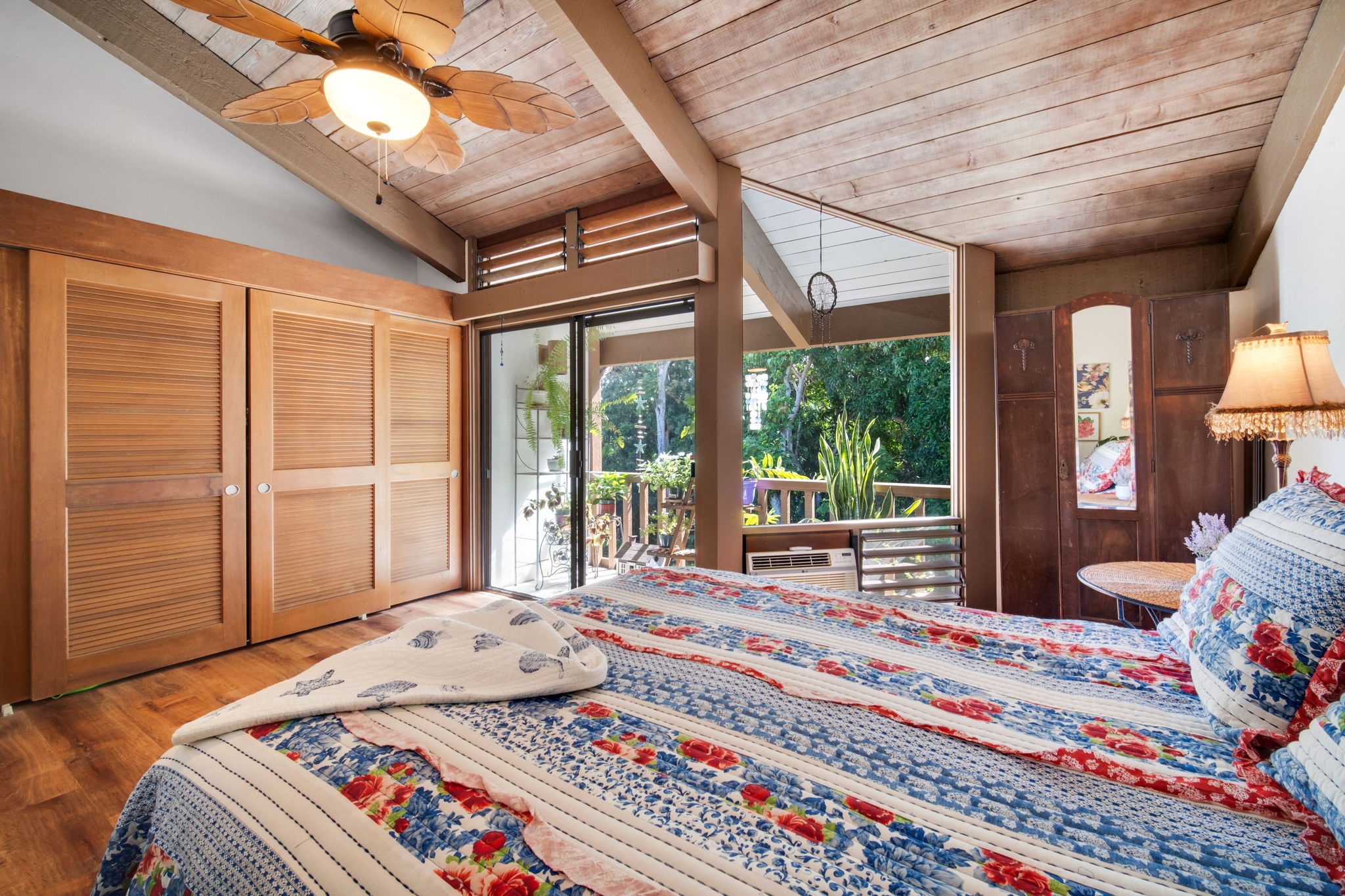 4701 Kawaihau Road, Unit F201 Kapaa, HI 96746 - Photo 10 of 24 a bedroom with a bed and wooden floor