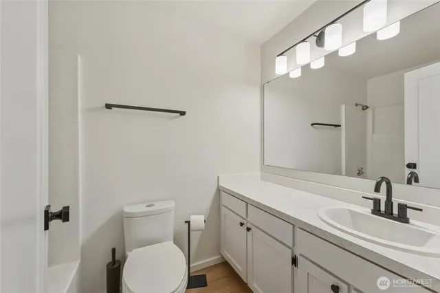 a bathroom with a sink a toilet and a mirror