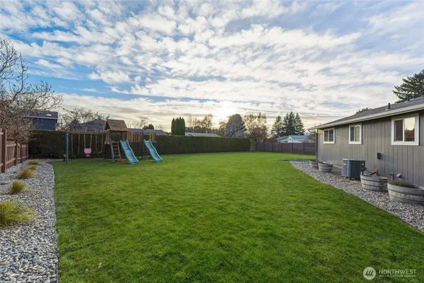 a front view of a house with a garden and yard
