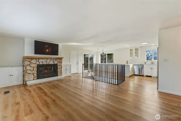 a view of a livingroom with a fireplace and window