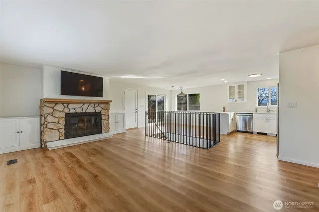 a view of a livingroom with a fireplace and window