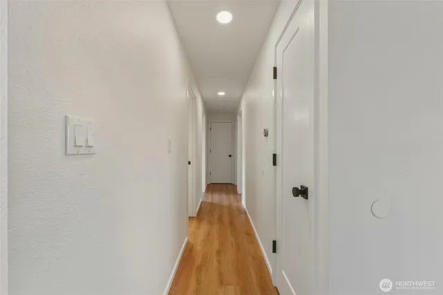 a view of a bathroom with shower and wooden floor