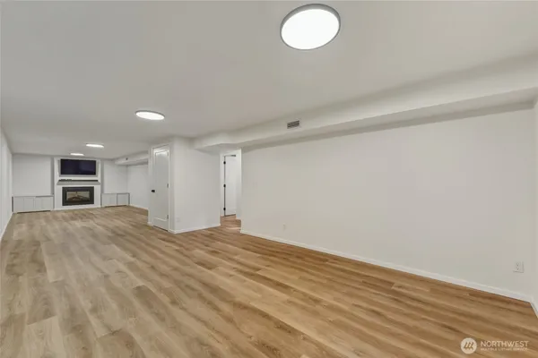a view of a bathroom with shower and wooden floor