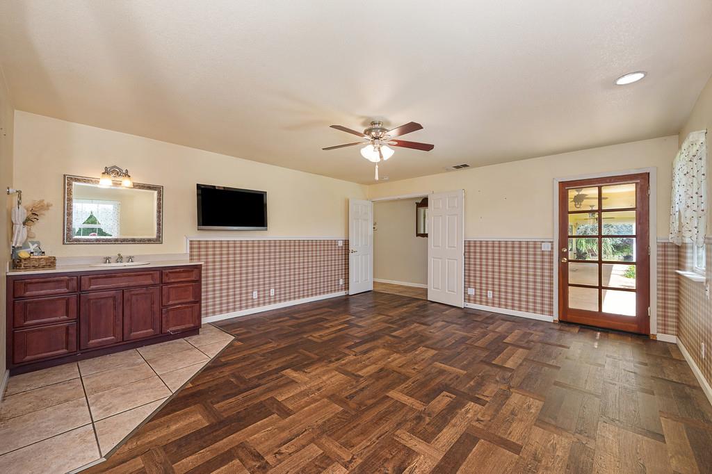 6181 Lambert Lane El Dorado, CA 95623 - Photo 43 of 68 unfurnished living room with wainscoting, parquet flooring, and ceiling fan