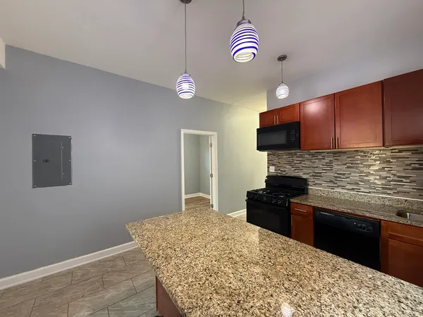 a kitchen with stainless steel appliances kitchen island granite countertop a stove top oven a sink and dishwasher