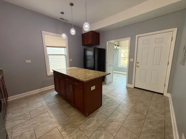 a kitchen with a cabinets and chandelier