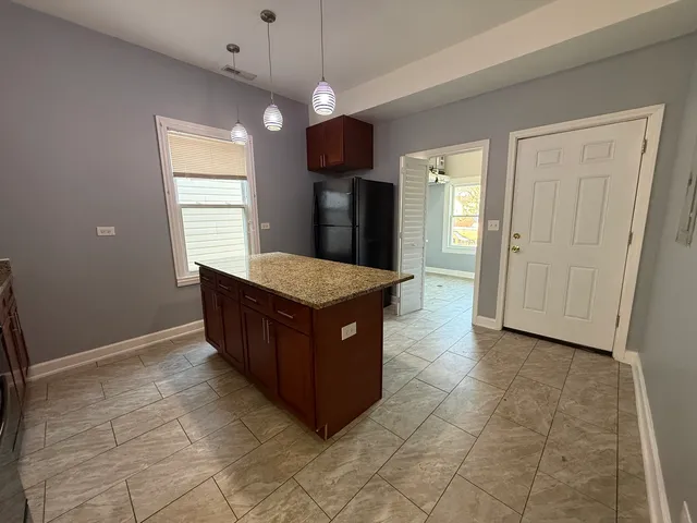 a kitchen with a cabinets and chandelier