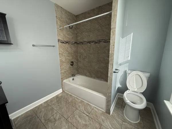 a bathroom with a toilet and a shower