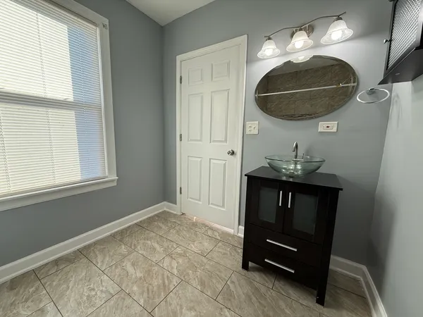 a bedroom with a bed and a mirror