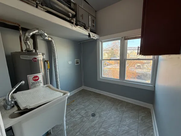 a view of a hallway with furniture and a window
