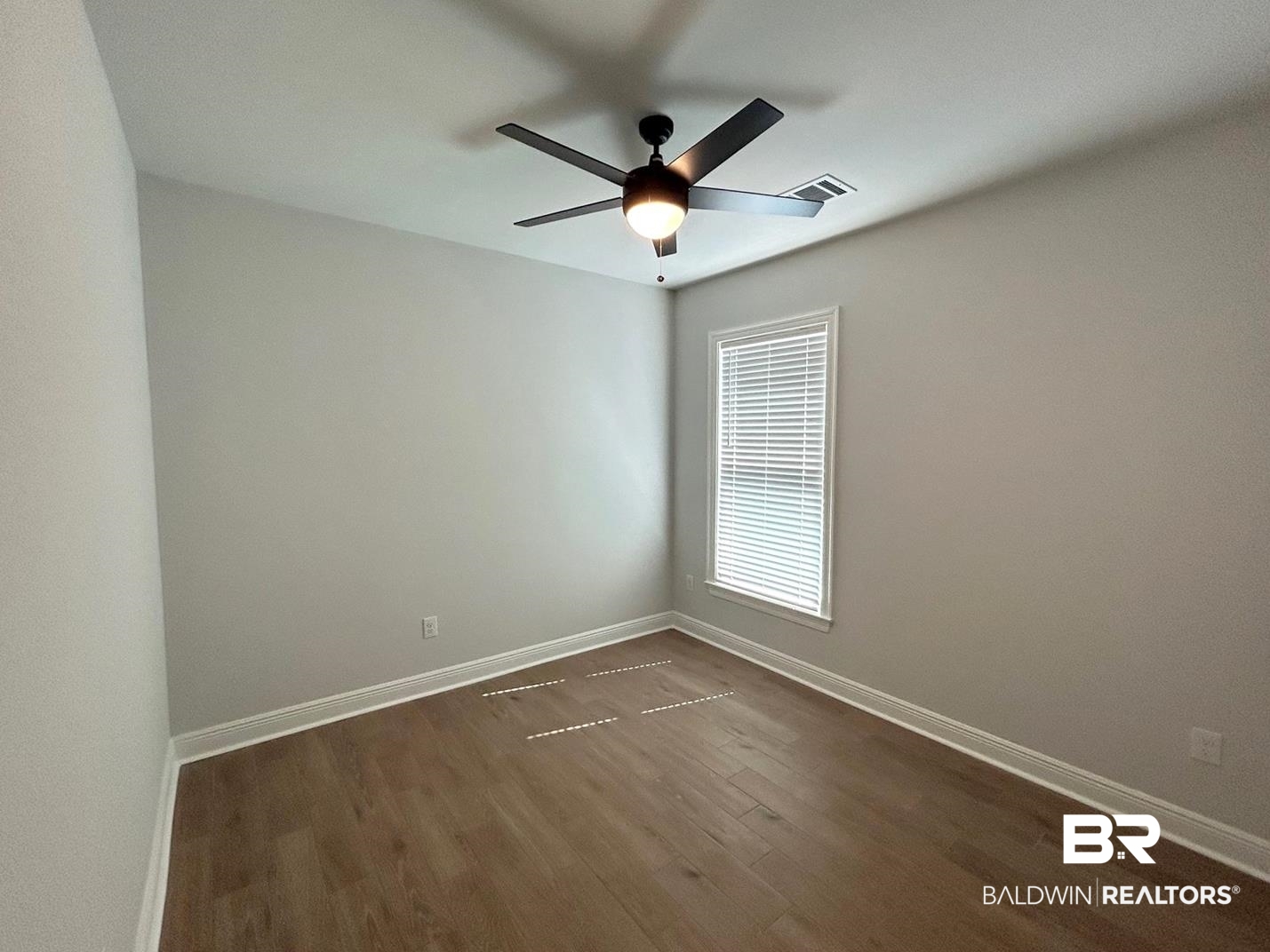 884 Sumter Loop Foley, AL 36535 - Photo 15 of 18 Spare room featuring dark wood-type flooring and ceiling fan