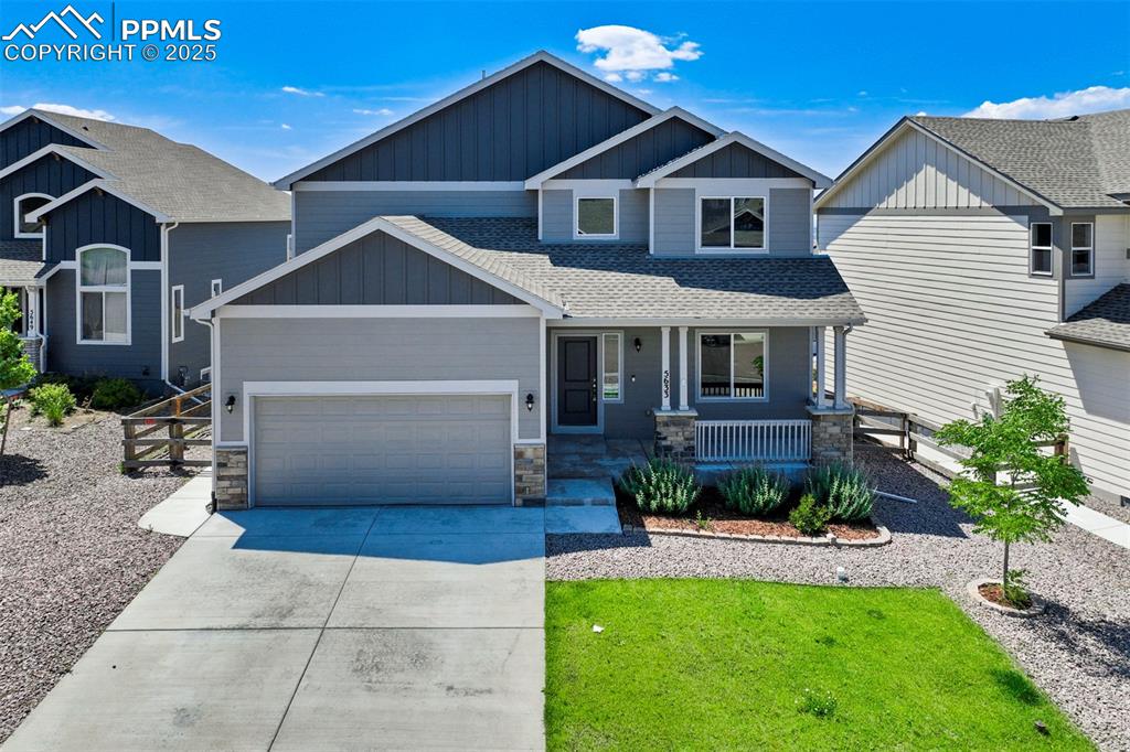 5633 Makalu Drive Colorado Springs, CO 80924 - Photo 1 of 48 a front view of a house with a yard and porch