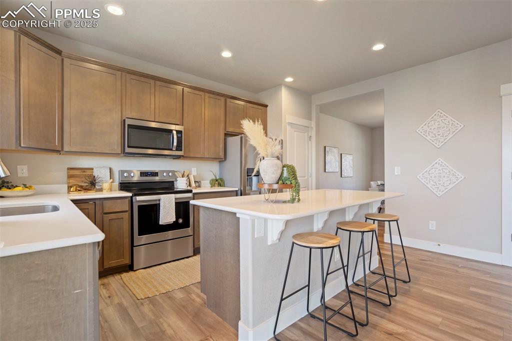 5633 Makalu Drive Colorado Springs, CO 80924 - Photo 12 of 48 a kitchen with a stove a sink and a refrigerator