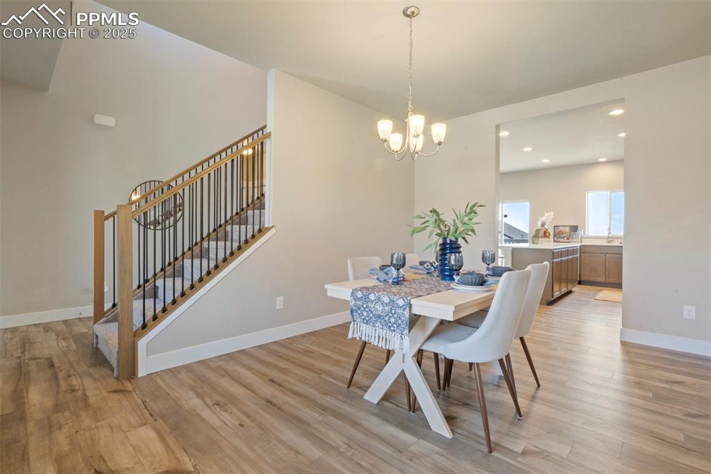 5633 Makalu Drive Colorado Springs, CO 80924 - Photo 15 of 48 a view of a dining room with furniture wooden floor and chandelier