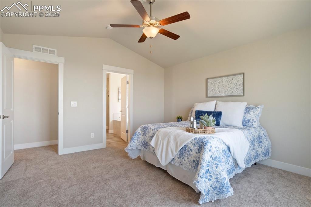 5633 Makalu Drive Colorado Springs, CO 80924 - Photo 24 of 48 a bedroom with a bed and a ceiling fan