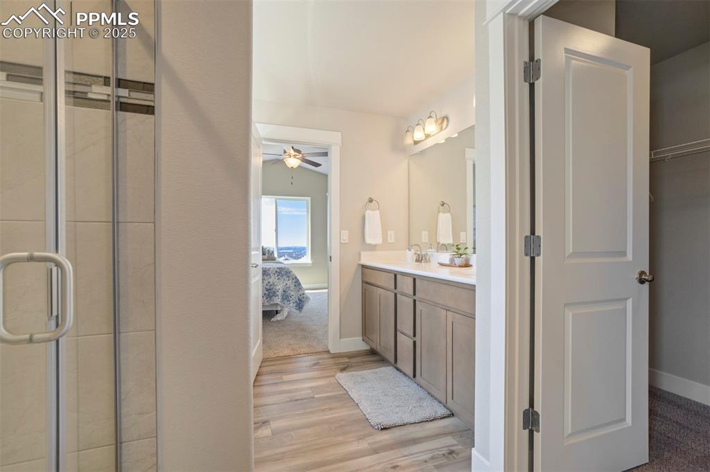 5633 Makalu Drive Colorado Springs, CO 80924 - Photo 27 of 48 a bathroom with a granite countertop sink a toilet and shower tap