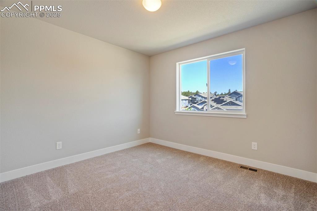 5633 Makalu Drive Colorado Springs, CO 80924 - Photo 31 of 48 an empty room with a painting on the wall