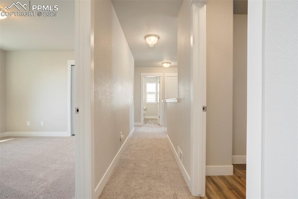 5633 Makalu Drive Colorado Springs, CO 80924 - Photo 35 of 48 a view of a hallway with wooden floor