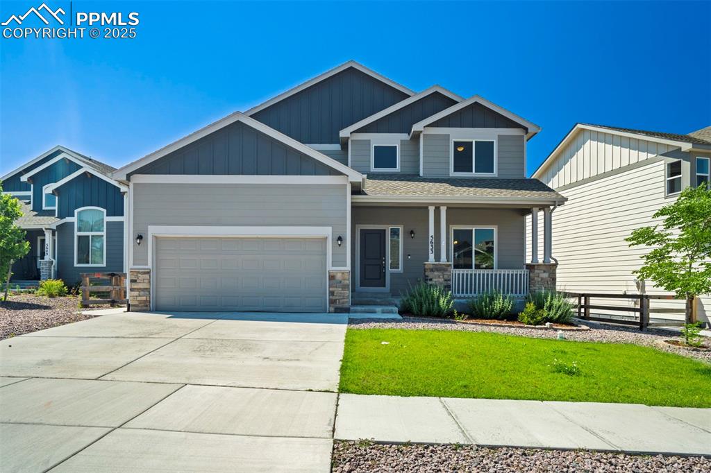 5633 Makalu Drive Colorado Springs, CO 80924 - Photo 4 of 48 a front view of a house with a yard and garage