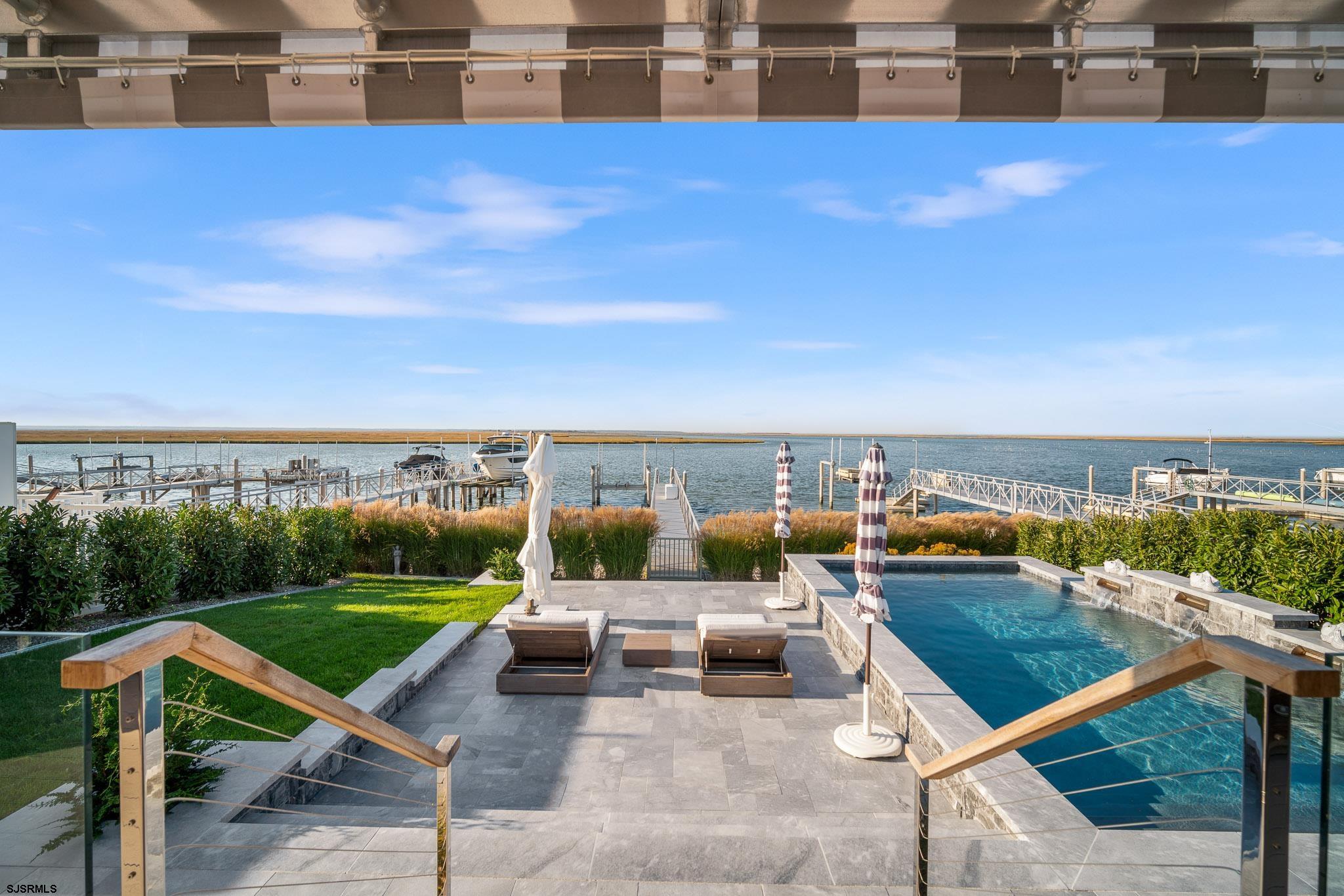 10 Golf Course Drive Brigantine, NJ 08203 - Photo 2 of 56 a view of a terrace with lawn chairs