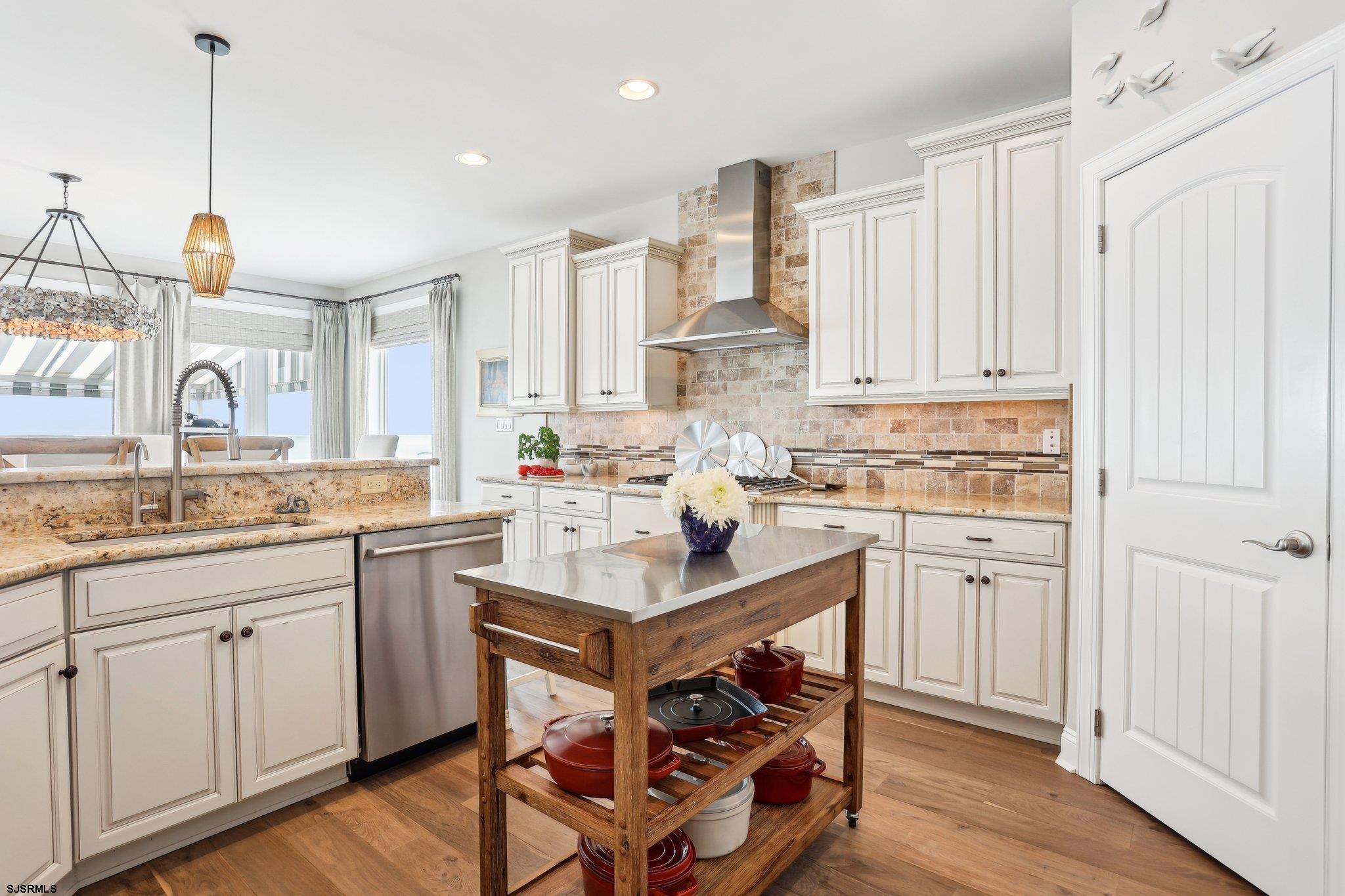 10 Golf Course Drive Brigantine, NJ 08203 - Photo 25 of 56 a kitchen with white cabinets and sink