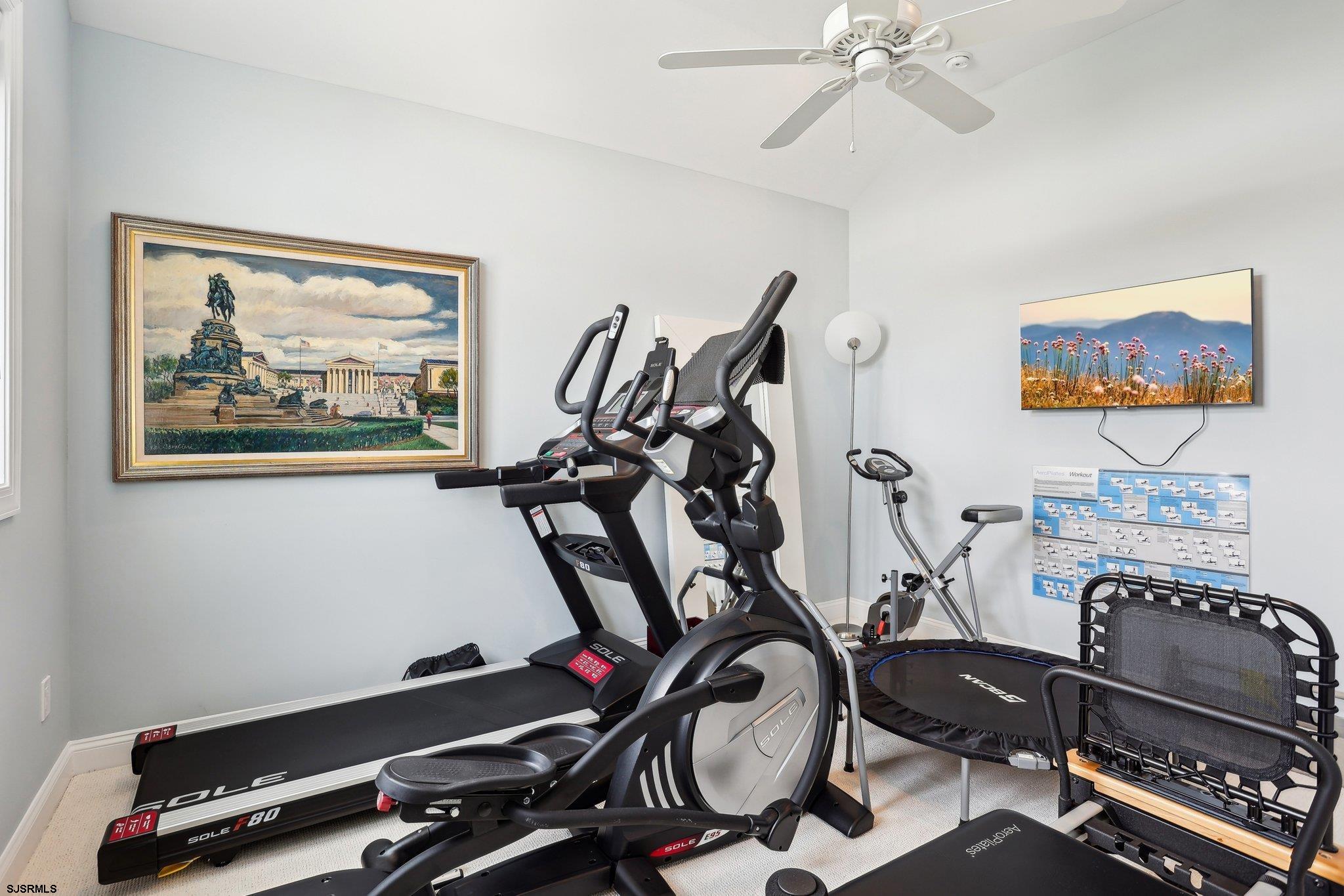 10 Golf Course Drive Brigantine, NJ 08203 - Photo 42 of 56 a room with gym equipment and mirror