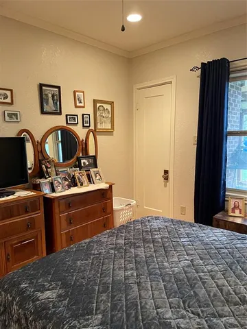 a bedroom with a bed and a television