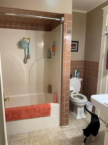 a bathroom with a bathtub toilet and sink