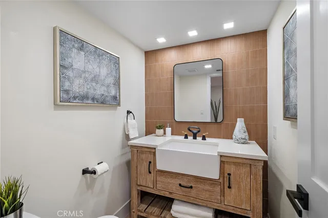 a bathroom with a sink mirror and toilet