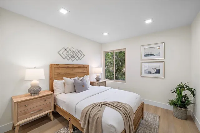 a bedroom with a bed and a potted plant