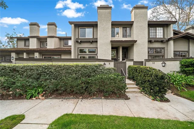 a front view of a residential apartment building with a yard