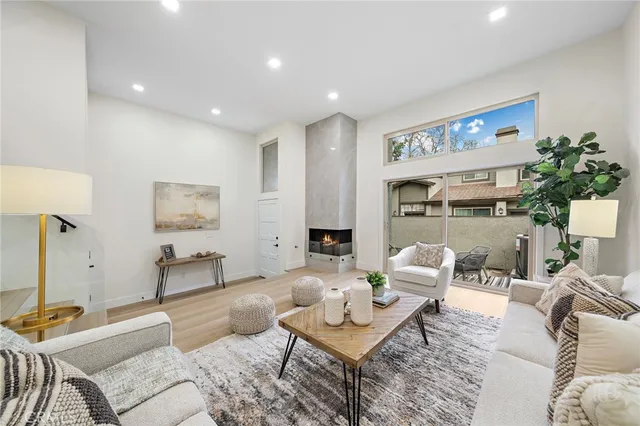 a living room with furniture and a painting on the wall