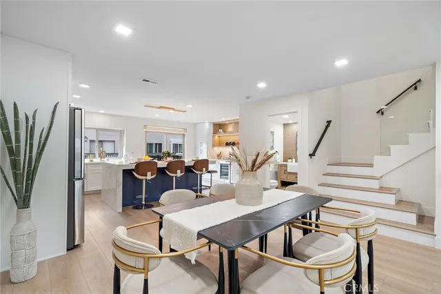 a living room with furniture a dining table and a potted plant