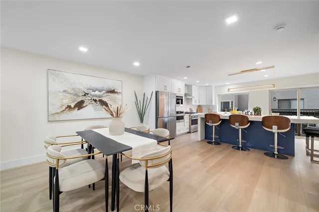 a living room with lots of furniture and a large window