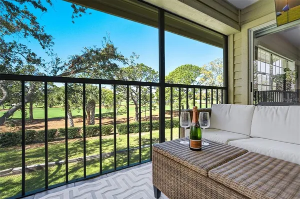 a view of a balcony with lake view and wooden floor